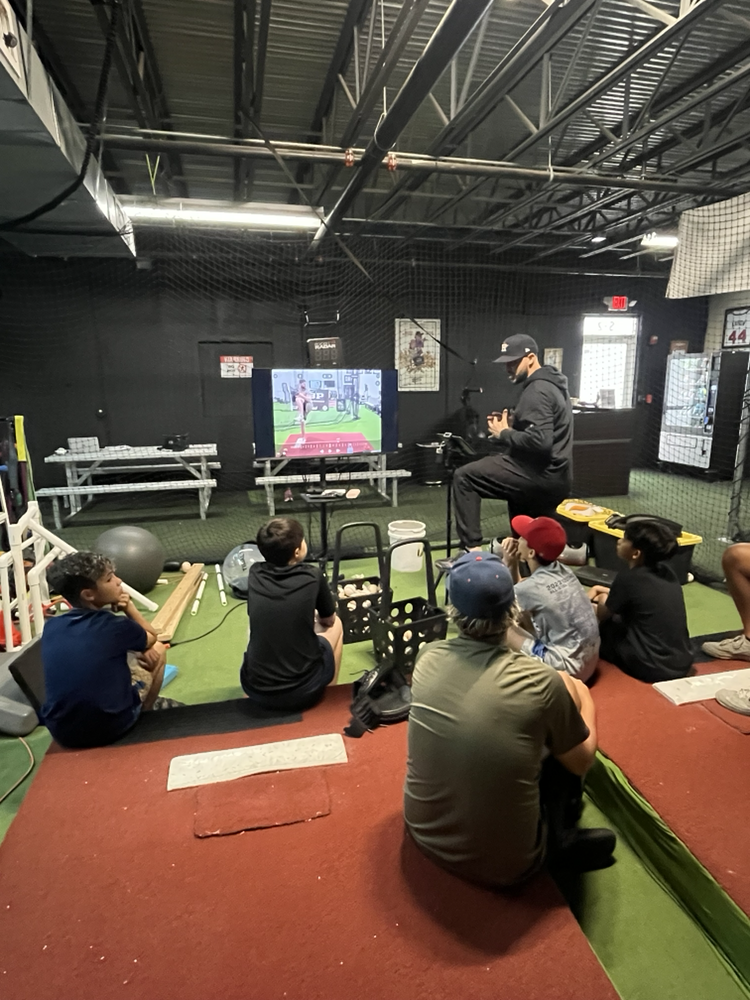 Coach guiding athletes through a training session at All Star Training Center